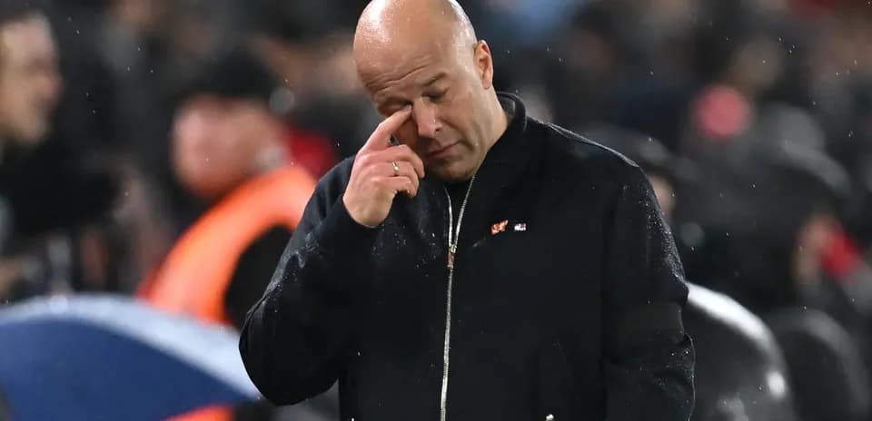 Coach wiping his eye during rainy match