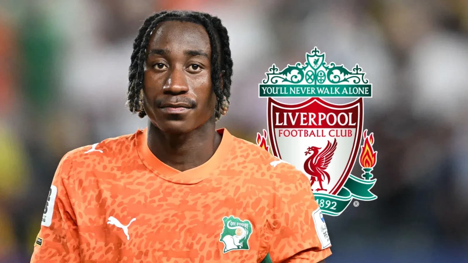 Goalkeeper in orange jersey with Liverpool logo background
