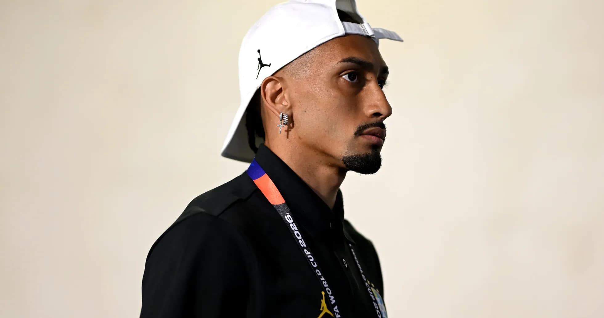 Person wearing a cap and lanyard, side profile