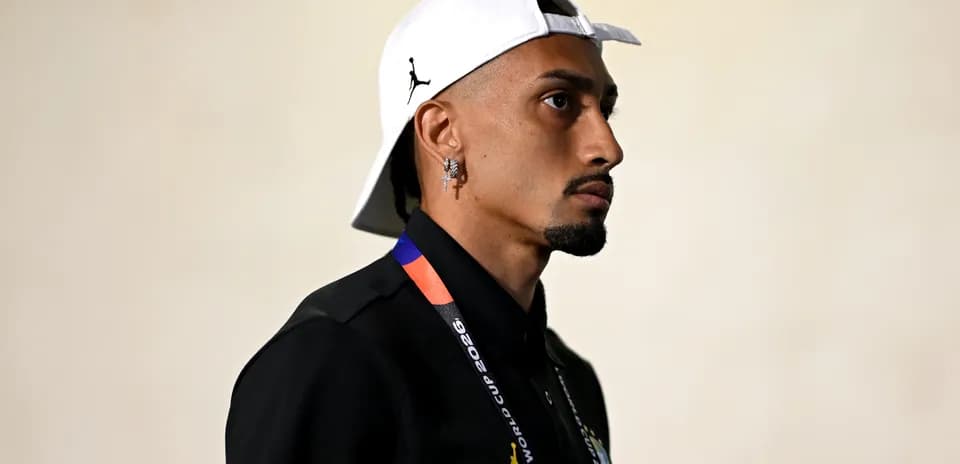Person wearing a cap and lanyard, side profile