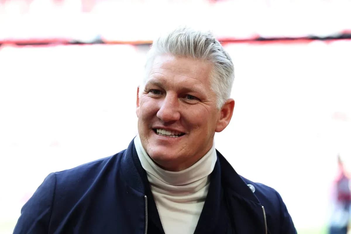 Former player smiling in a stadium setting