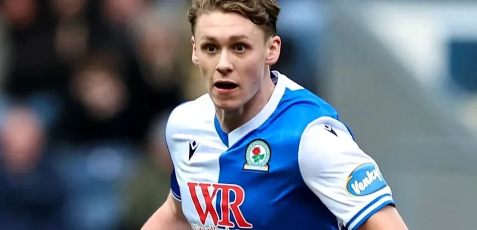 Player in blue and white kit running during match