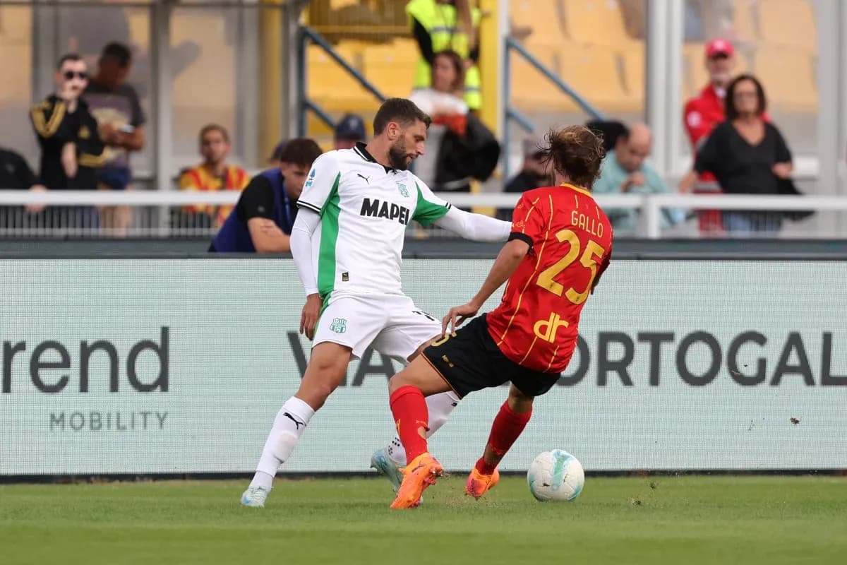 Sassuolo player challenging Lecce opponent during match