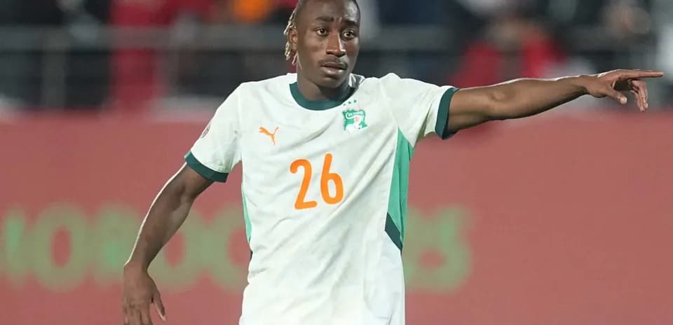 Player in Ivorian jersey signaling during match