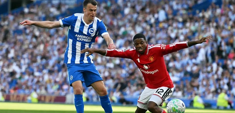 Brighton and Manchester United players competing for the ball