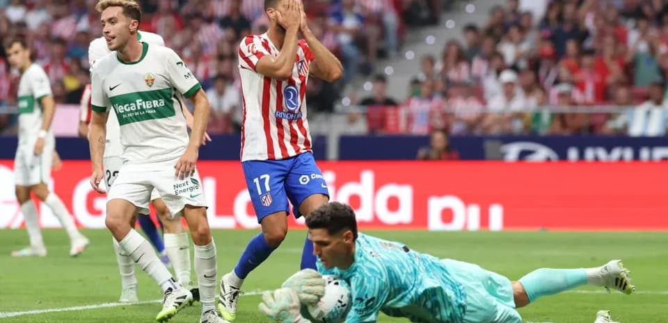 Elche player reacts as Atletico Madrid goalkeeper saves