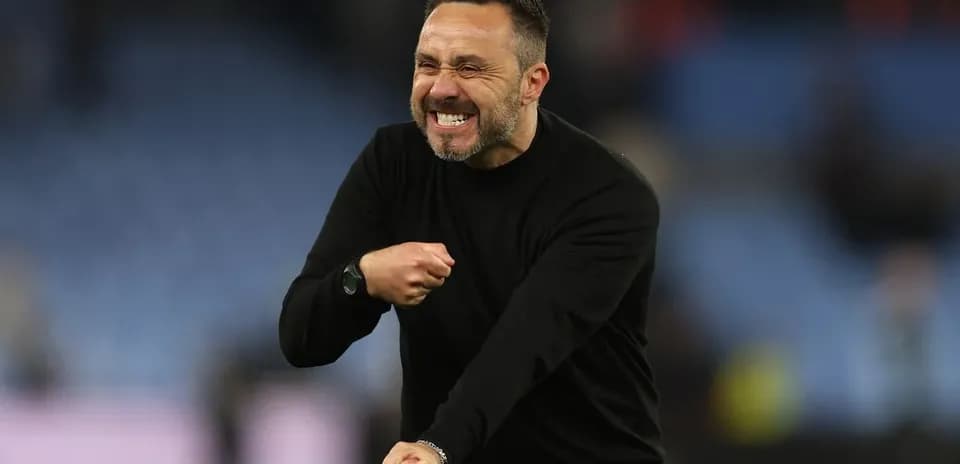 Coach celebrating passionately on the sidelines