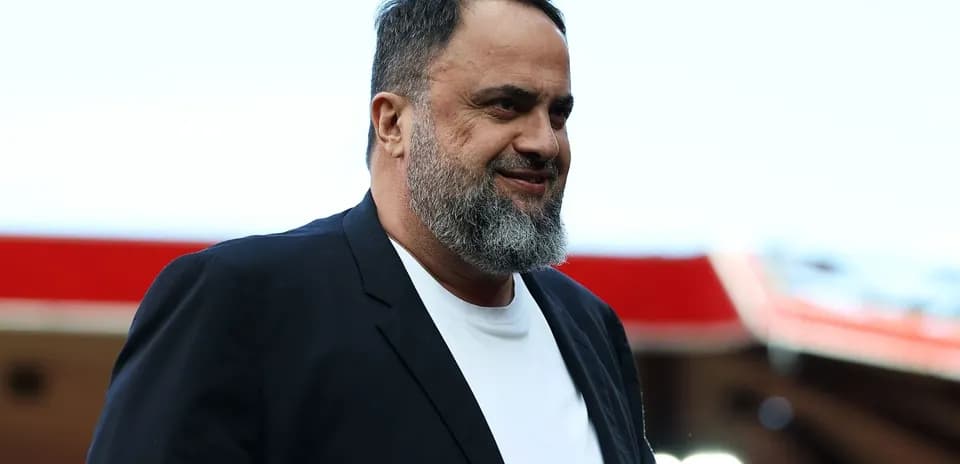 Man with beard walking in stadium area