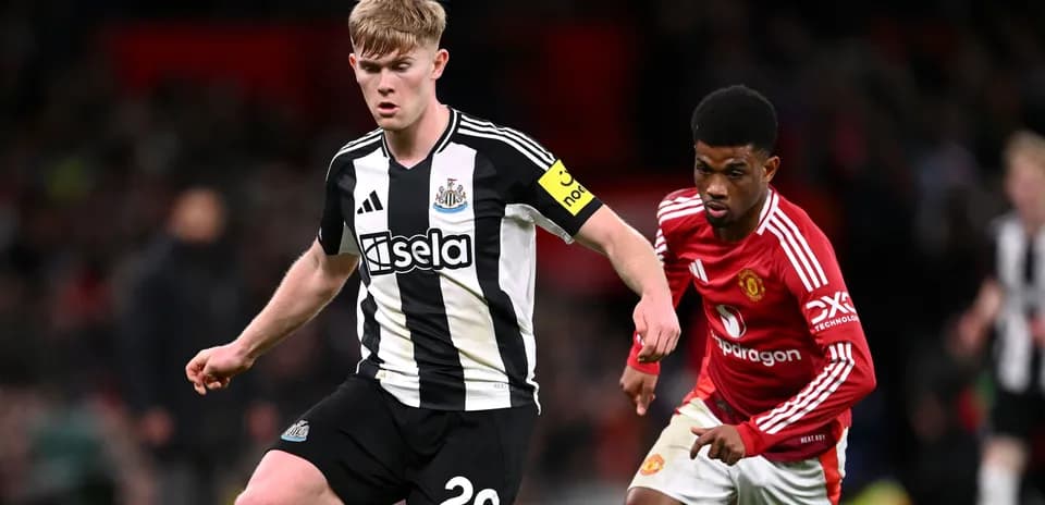 Newcastle player dribbling past Manchester United opponent