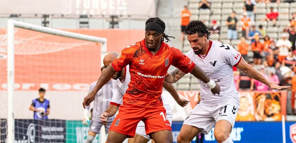 Players battling for possession during match