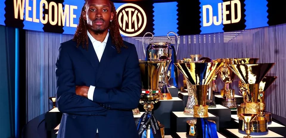 New player posing with trophies at announcement event