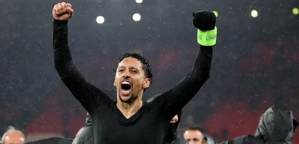 Player celebrating with raised fists in rain