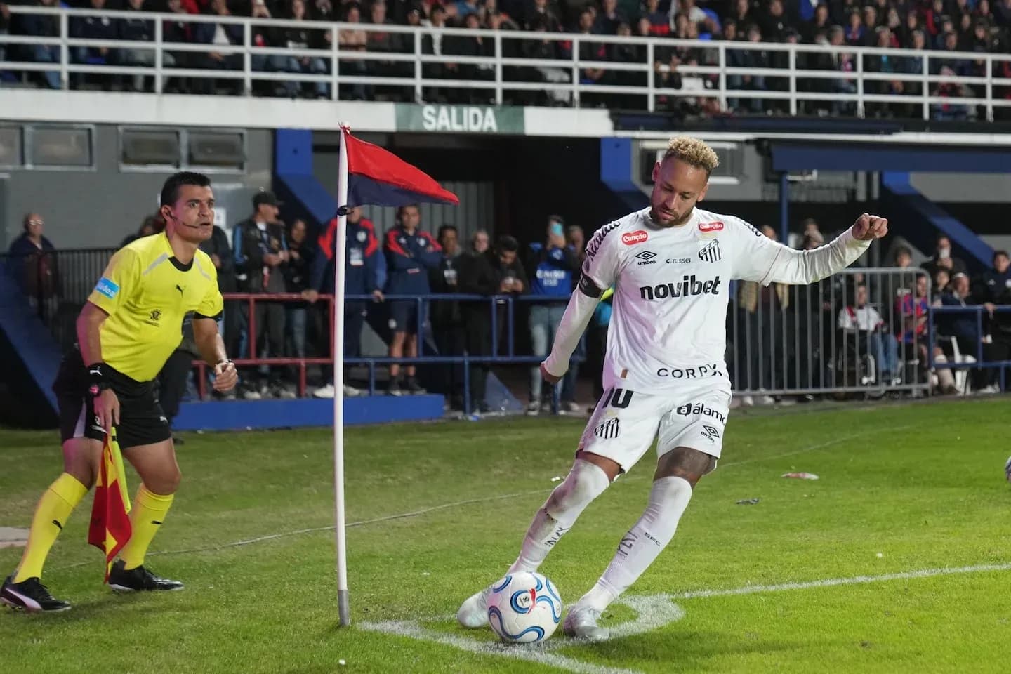 Player taking a corner kick near flag