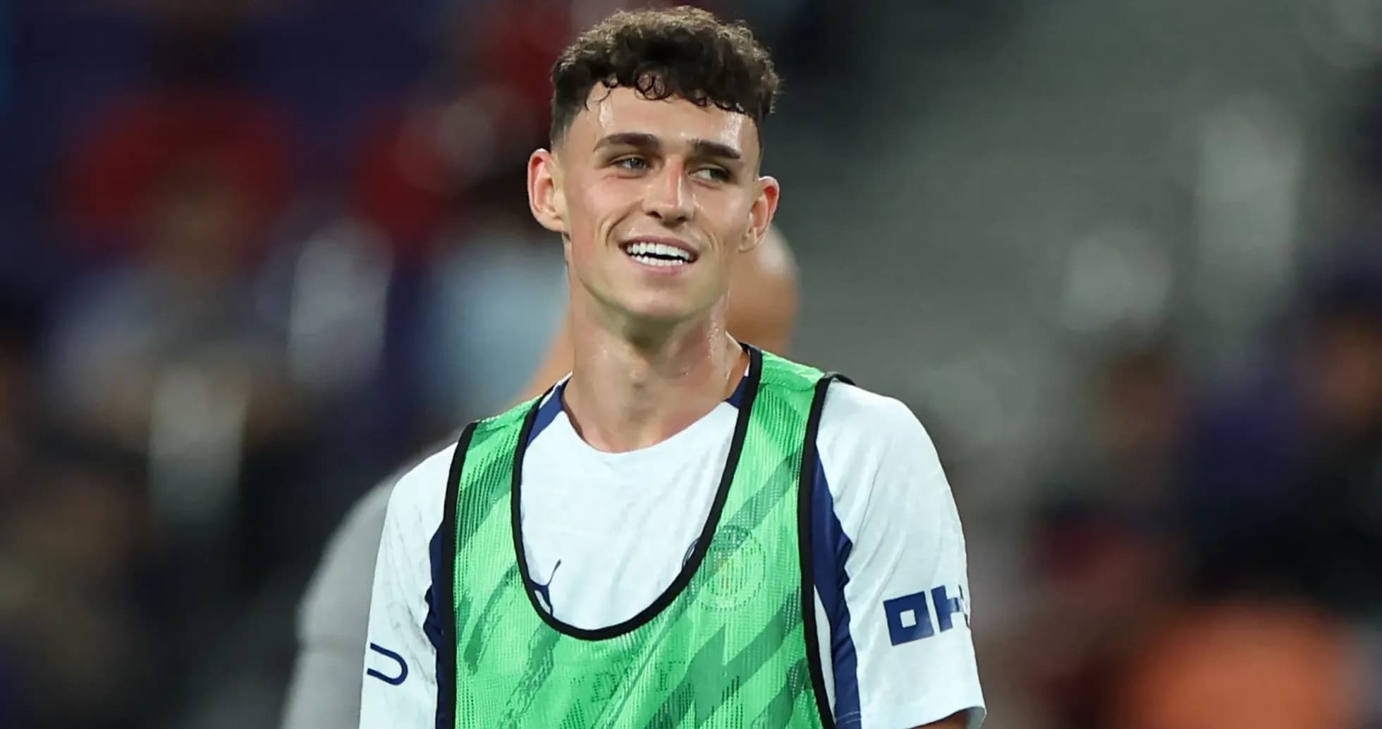 Player wearing training bib smiling on the field