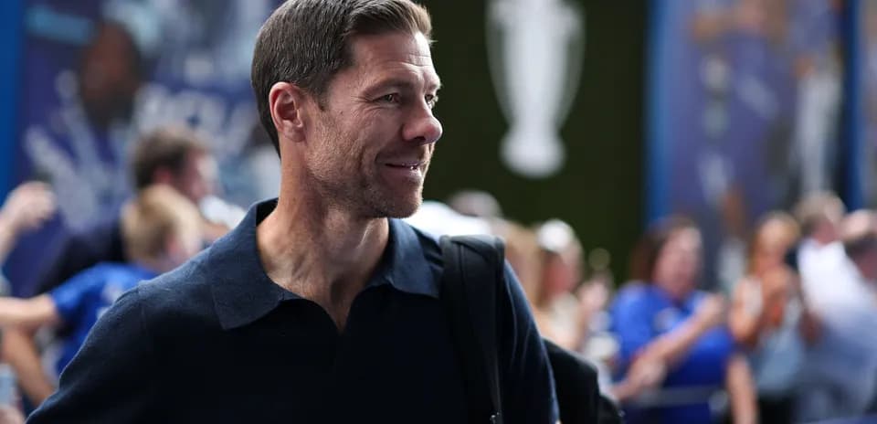 Man with backpack smiling at event entrance