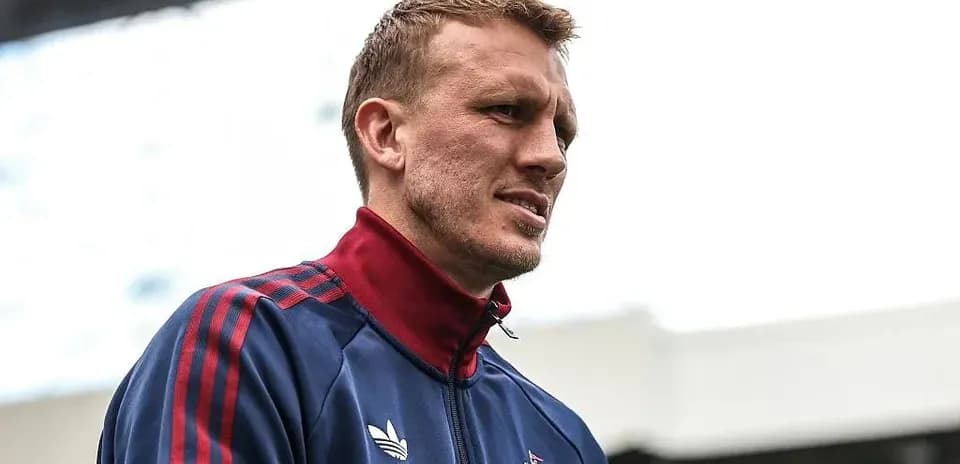 Player in training jacket at stadium entrance
