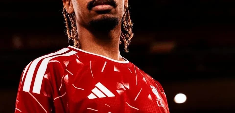 Player posing in red jersey with sponsor logo