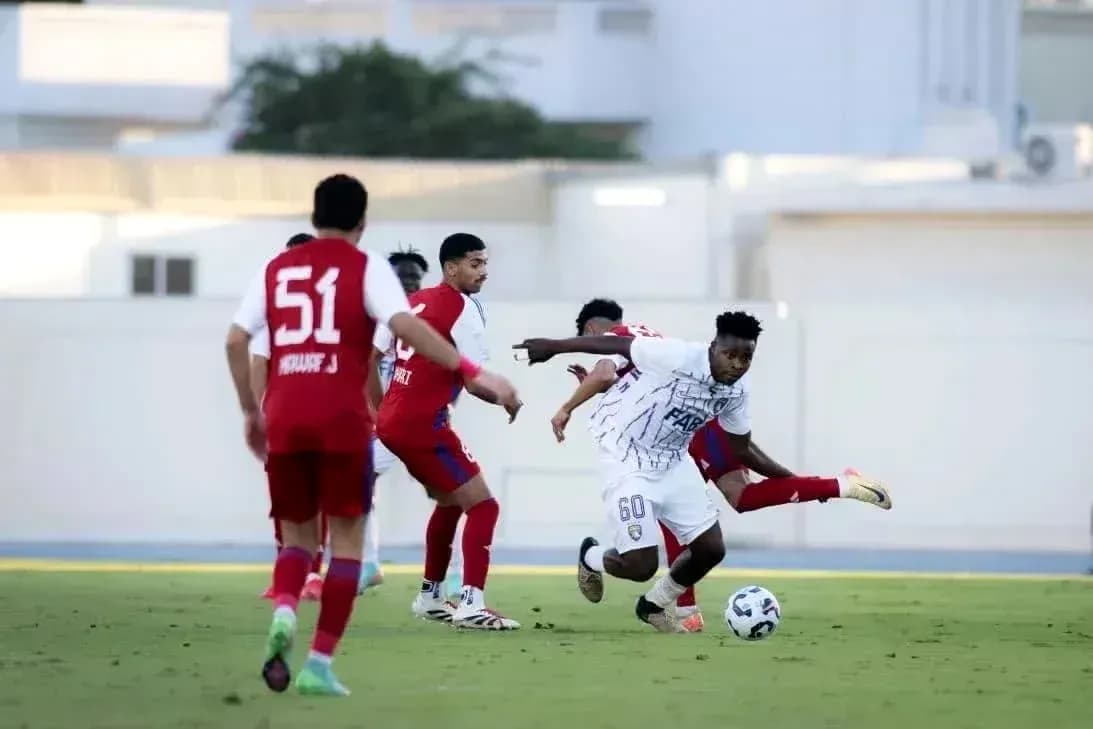 Dibba Al Fujairah U23 player dribbling past defenders