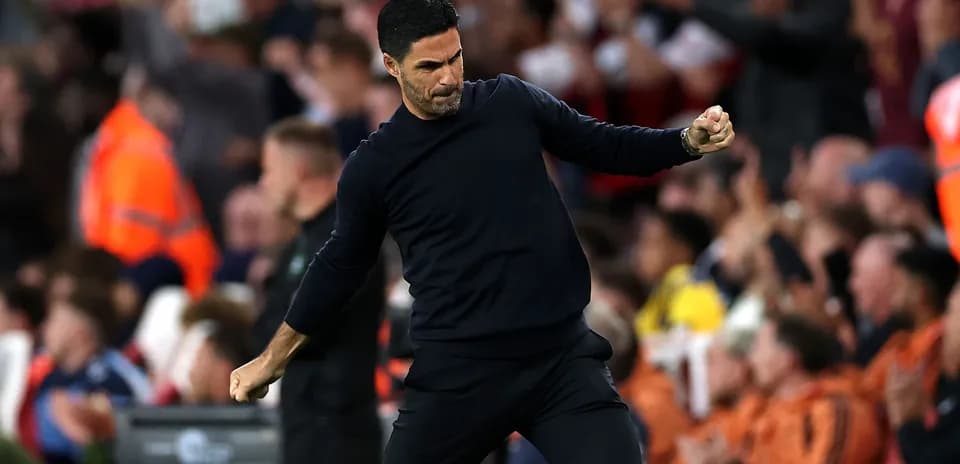 Manager celebrating in front of cheering crowd