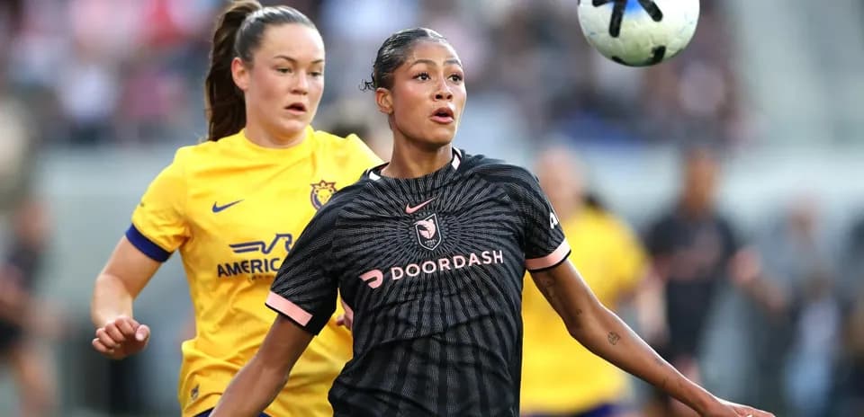 Players competing for the ball in NWSL match