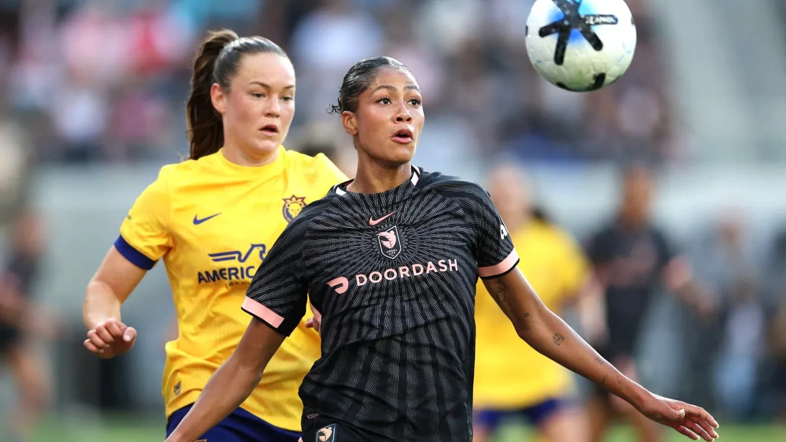 Players competing for the ball in NWSL match