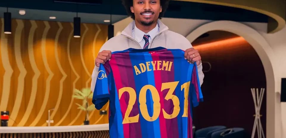 Player holding Barcelona jersey with name and number