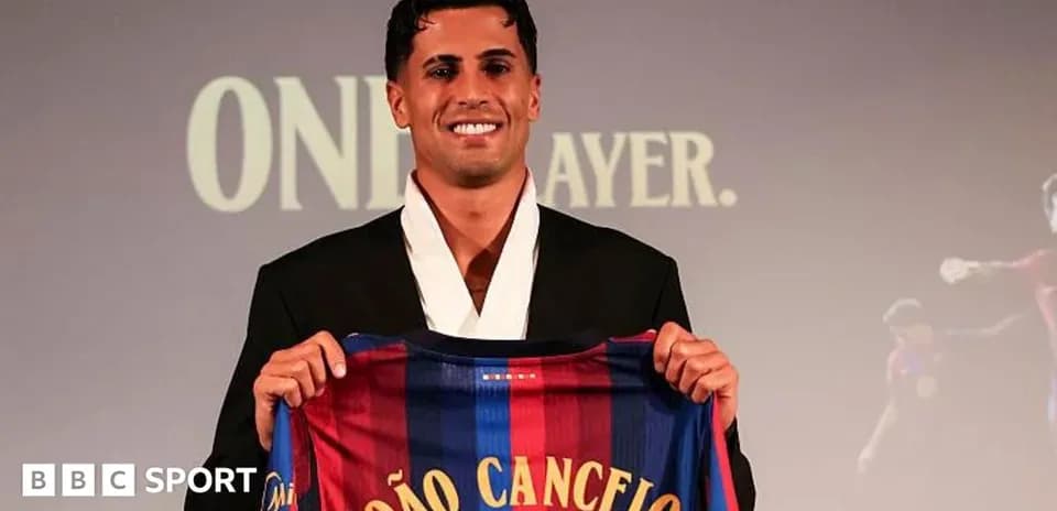 Player holding Barcelona jersey during presentation event