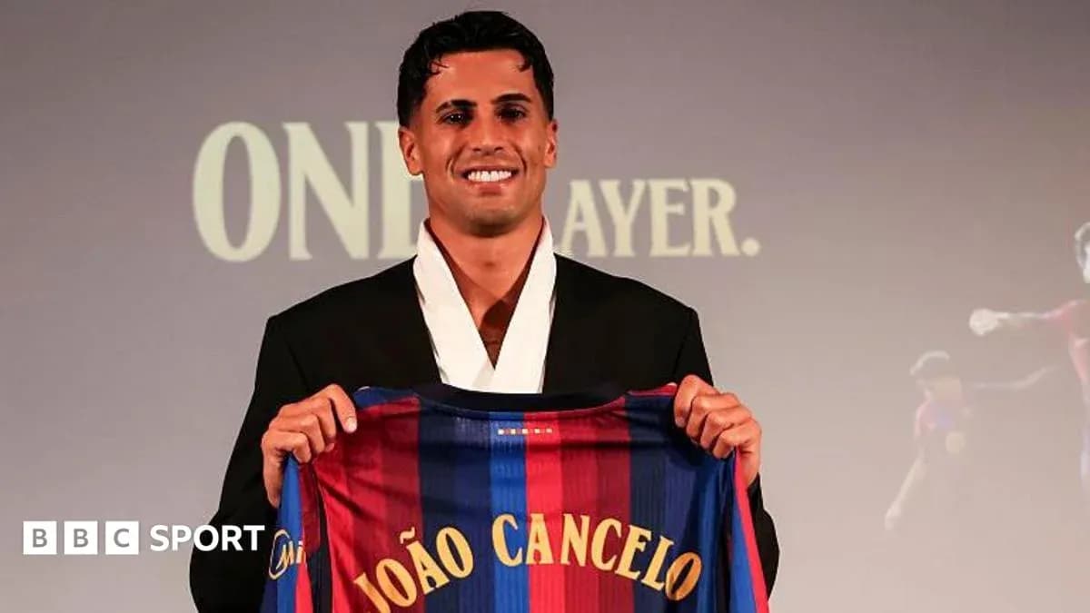 Player holding Barcelona jersey during presentation event
