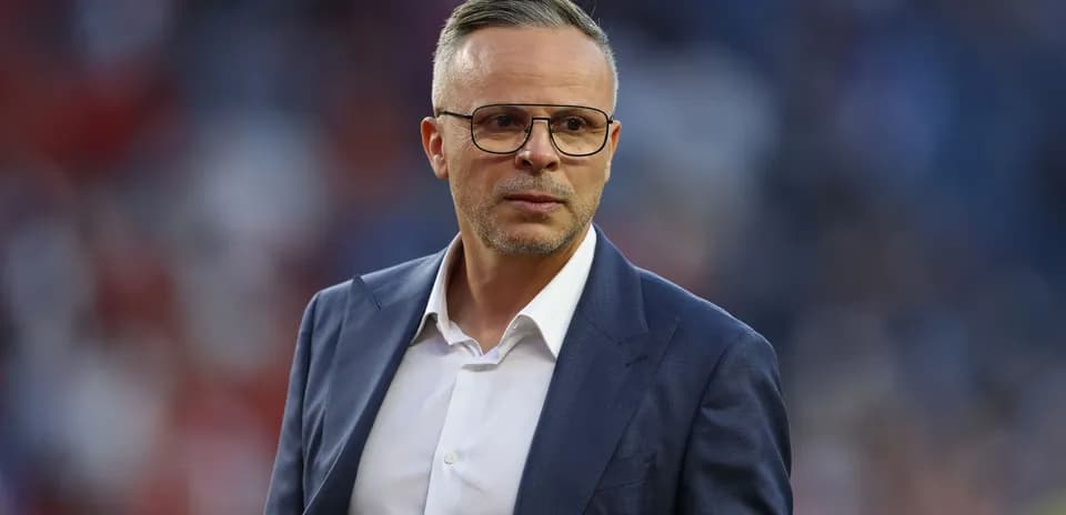 Coach in suit on the sidelines during match