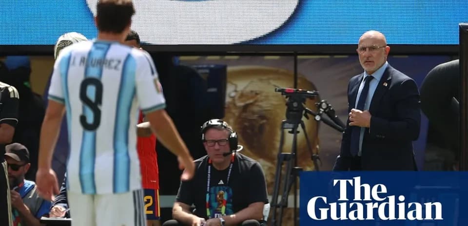 Argentina player leaving field with coach observing