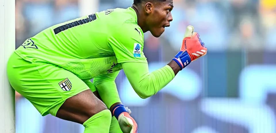 Goalkeeper in green uniform signaling during match