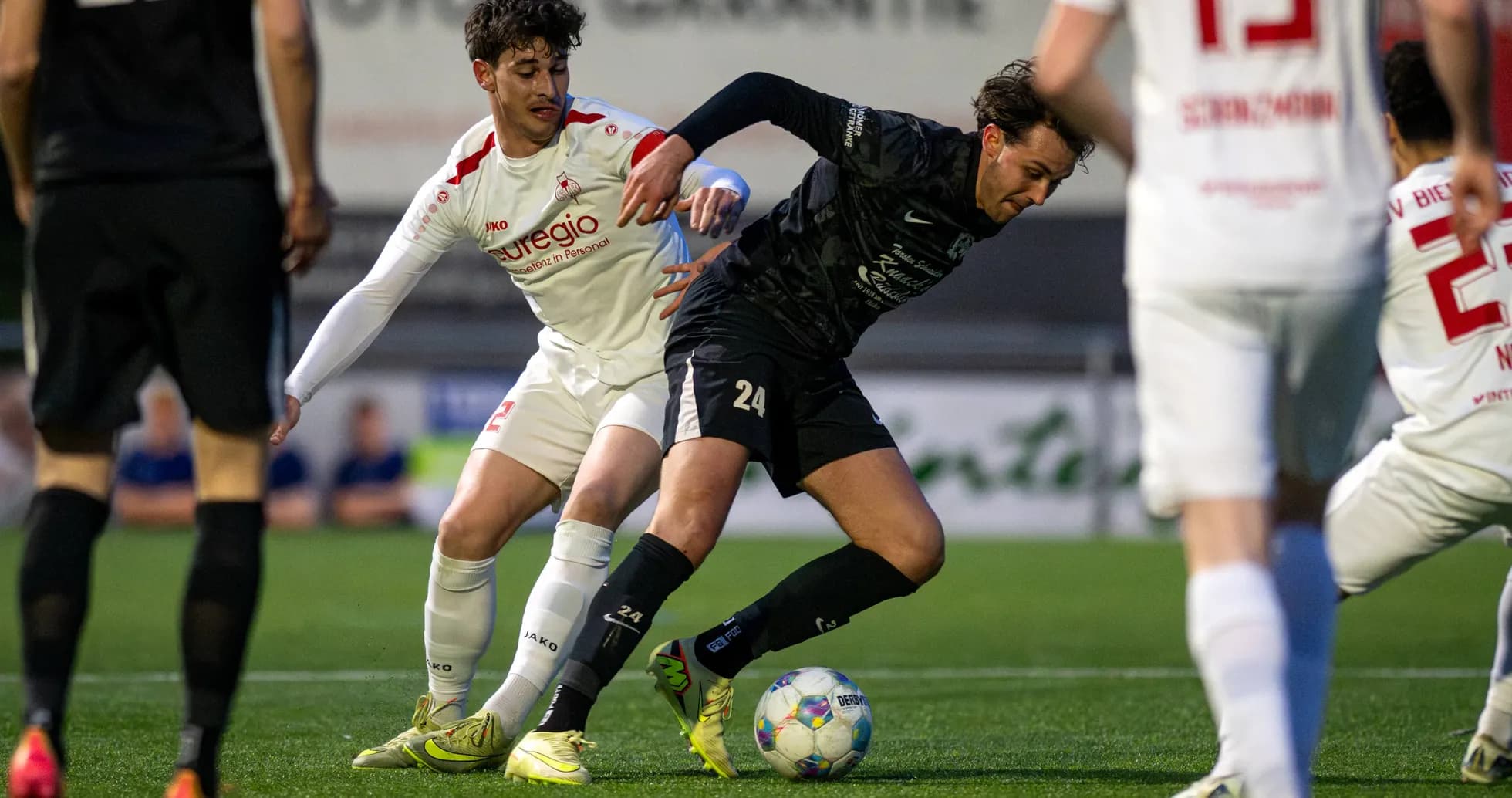 Players contesting for the ball in Oberliga match