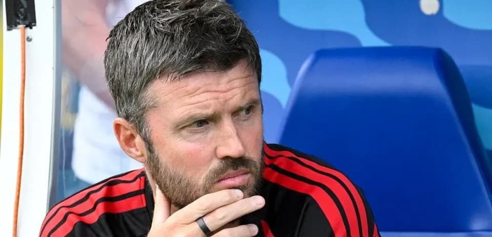 Coach seated on bench during match contemplation