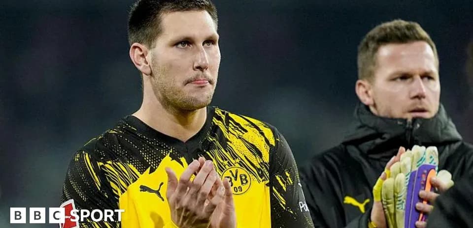 Goalkeeper applauding fans after match with teammate