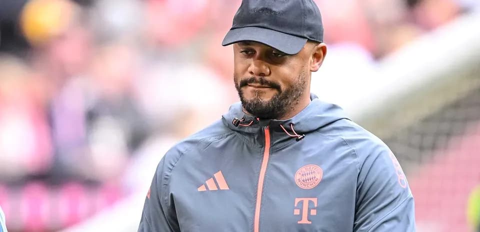 Person wearing Bayern Munich jacket and cap on field