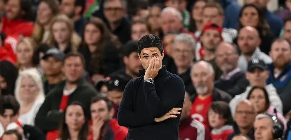 Manager watching match with fans in background
