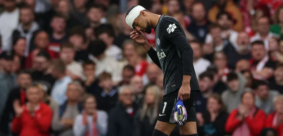 Goalkeeper walking off with a bandaged head
