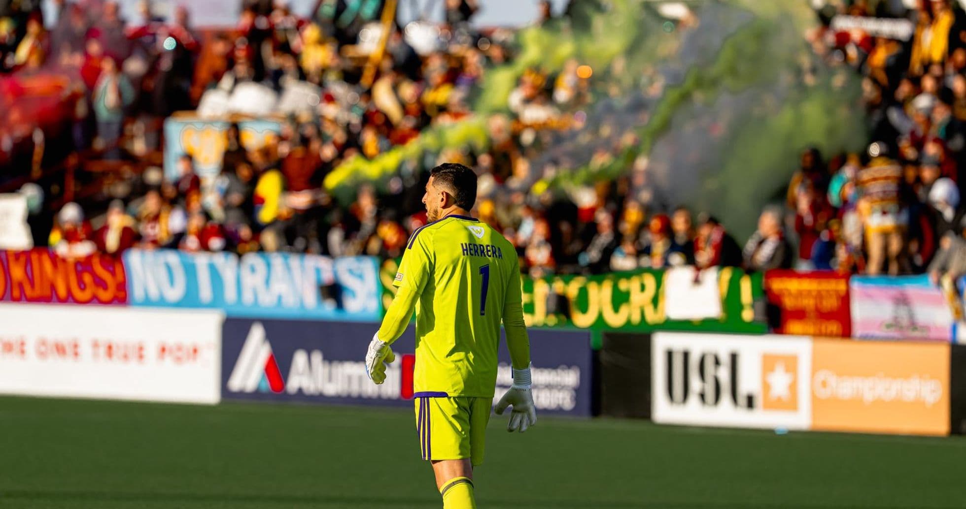 Goalkeeper during match with fans in background