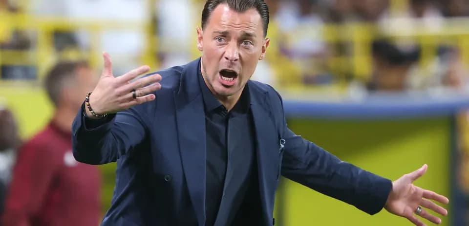 Coach gesturing animatedly during a match