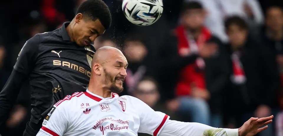 Two players contesting a header during match