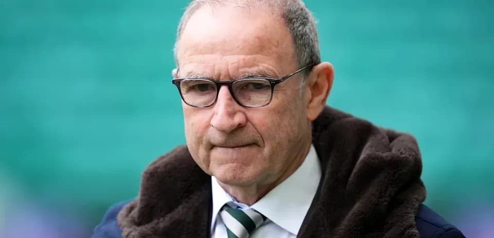 Man in glasses wearing a dark coat and tie
