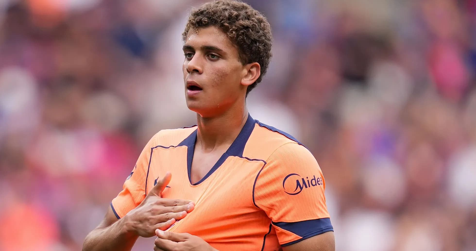 Player adjusting shirt during match warm-up