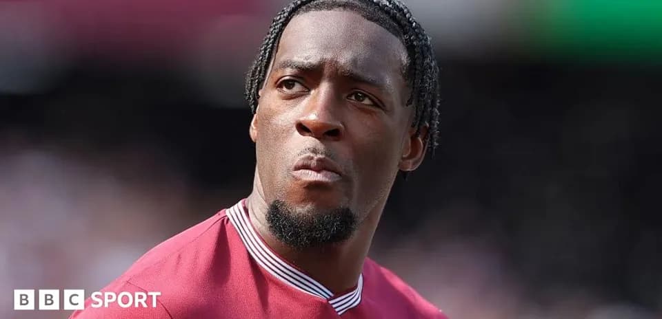 Player in maroon jersey looking focused during match