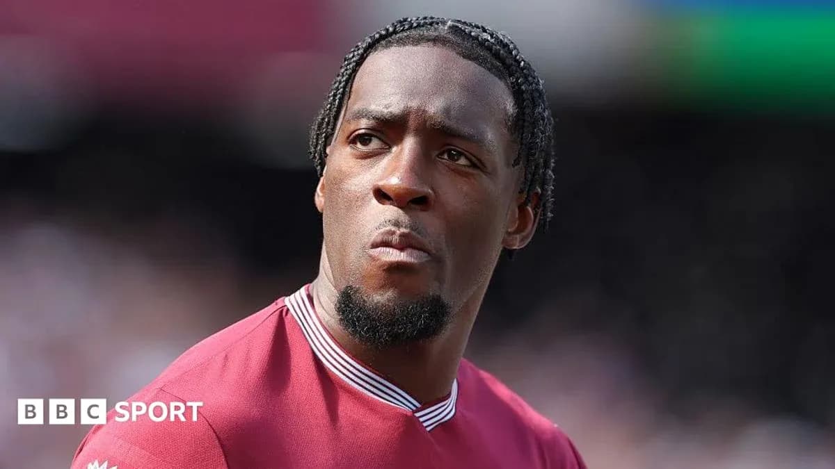 Player in maroon jersey looking focused during match