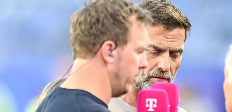 Two sports analysts discussing with microphones in hand