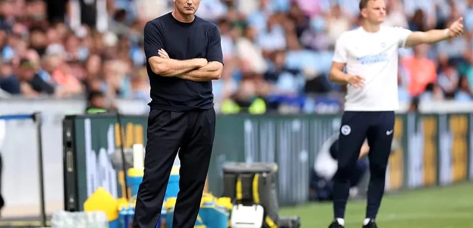 Two football coaches on the sideline during match