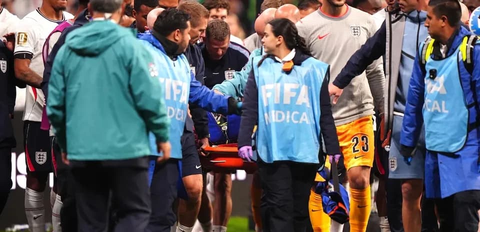 Medical staff attending injured player on stretcher