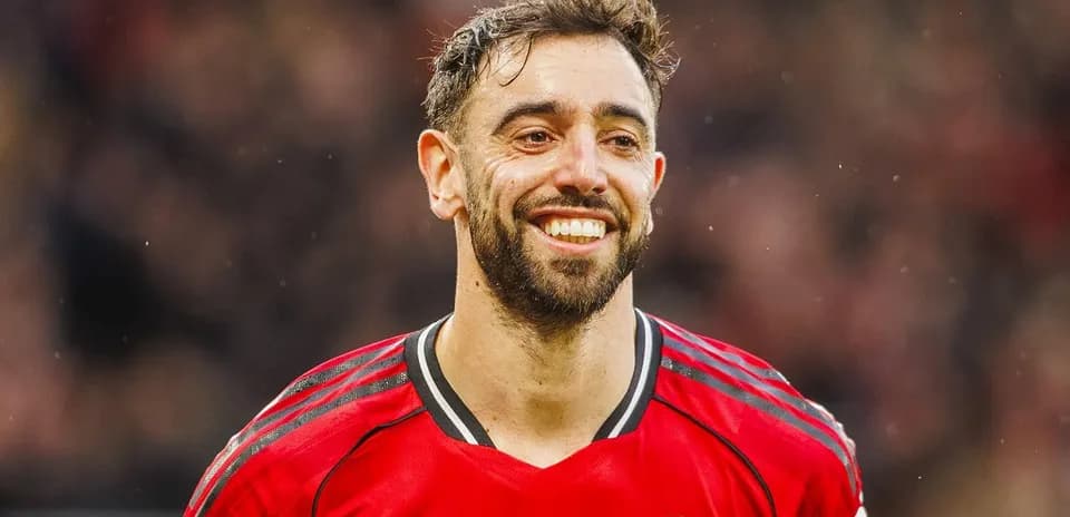 Player smiling in Manchester United jersey during match