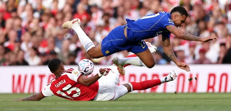 Player tackling another during a football match