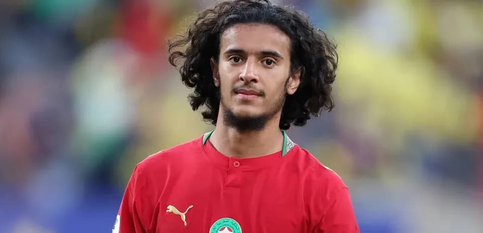 Player in red jersey standing on the field